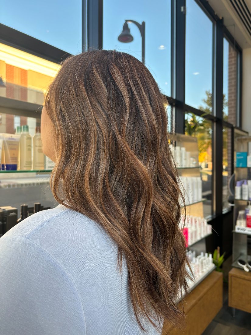 Soft brunette waves with warm caramel highlights at Essentials Salon, Warrington PA